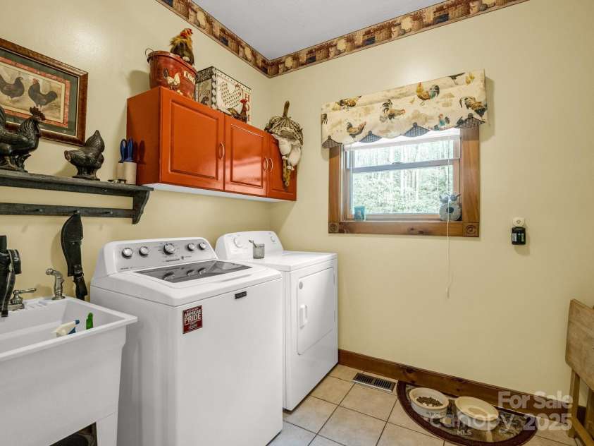 560 Charleys Knob Road, Pisgah Forest, NC 28768.  MLS# CAR4246535, YatesRealty ID 6002. Laundry room off kitchen