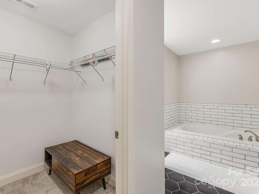 52 Kirby Road, Asheville, NC 28806.  MLS# CAR4227031, YatesRealty ID 6008. Primary bathroom with new tile and soaker tub and shower