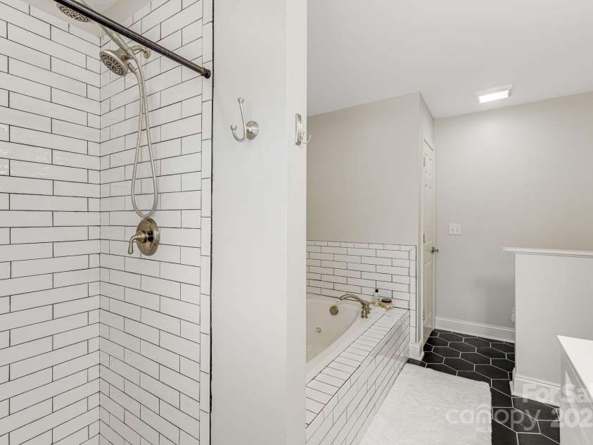 52 Kirby Road, Asheville, NC 28806.  MLS# CAR4227031, YatesRealty ID 6008. Primary bathroom with new tile and soaker tub and shower