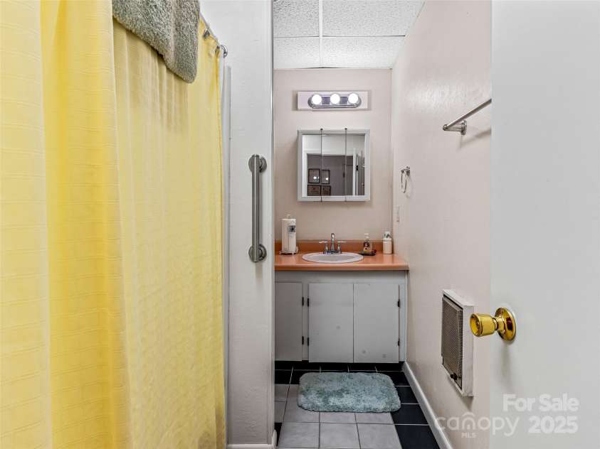29 Tall Oaks Road, Candler, NC 28715.  MLS# CAR4163907, YatesRealty ID 6016. Lower Level full bath