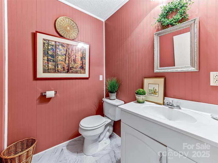 29 Tall Oaks Road, Candler, NC 28715.  MLS# CAR4163907, YatesRealty ID 6016. New laminate tile in main level 1/2 bath