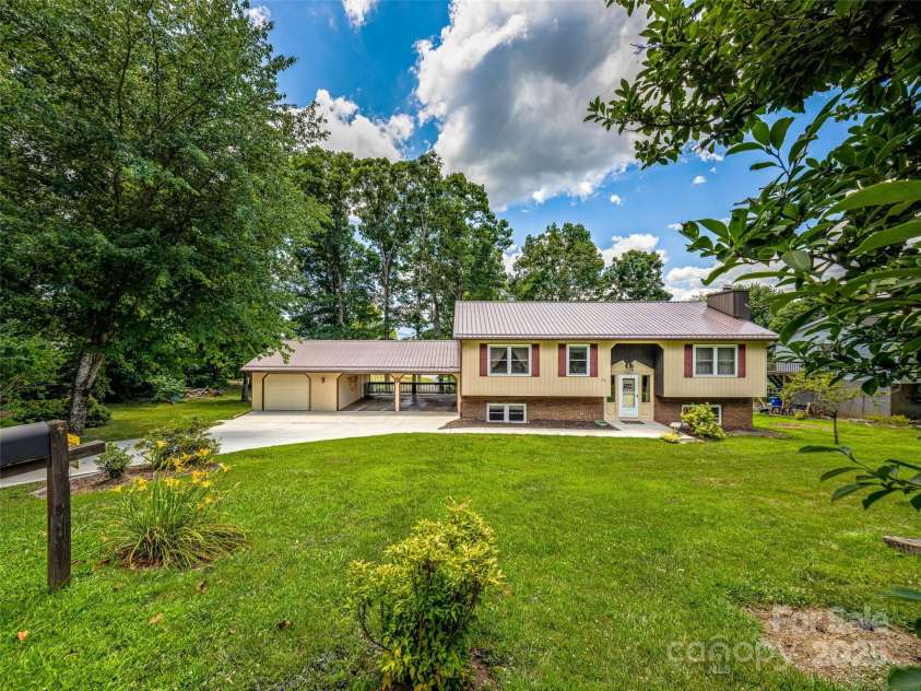29 Tall Oaks Road, Candler, NC 28715.  MLS# CAR4163907, YatesRealty ID 6016. Room for all the toys in the attached carport & garage