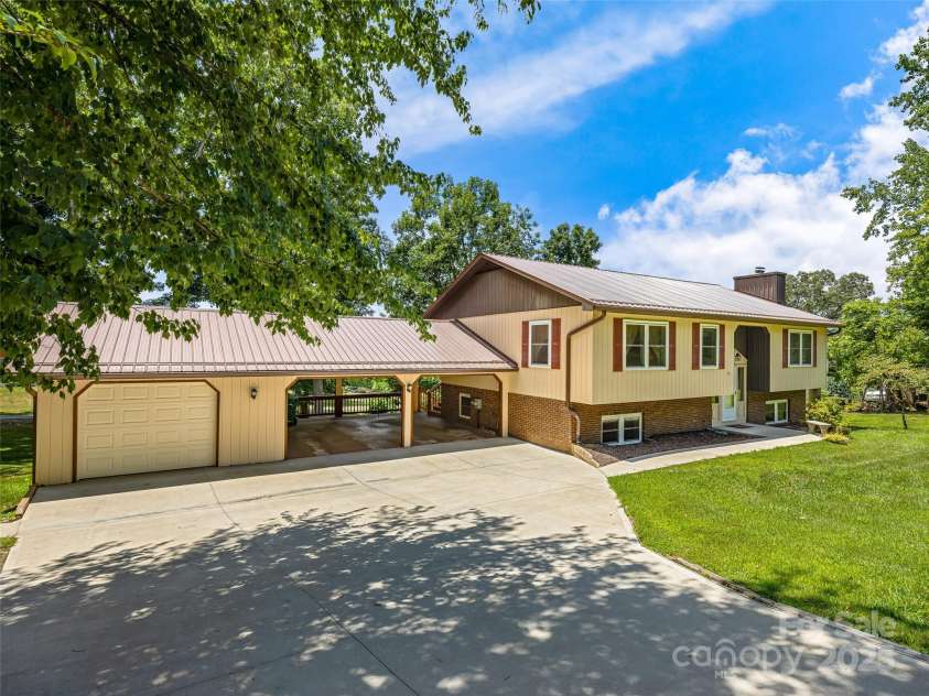 29 Tall Oaks Road, Candler, NC 28715.  MLS# CAR4163907, YatesRealty ID 6016. Room for all the toys in the attached carport & garage