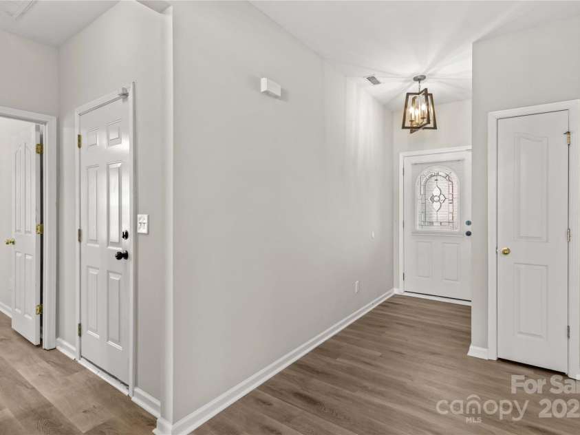 124 Zolder Lane, Mooresville, NC 28117.  MLS# CAR4213674, YatesRealty ID 6019. Foyer with new lighting, LVP flooring, coat closet, linen closet