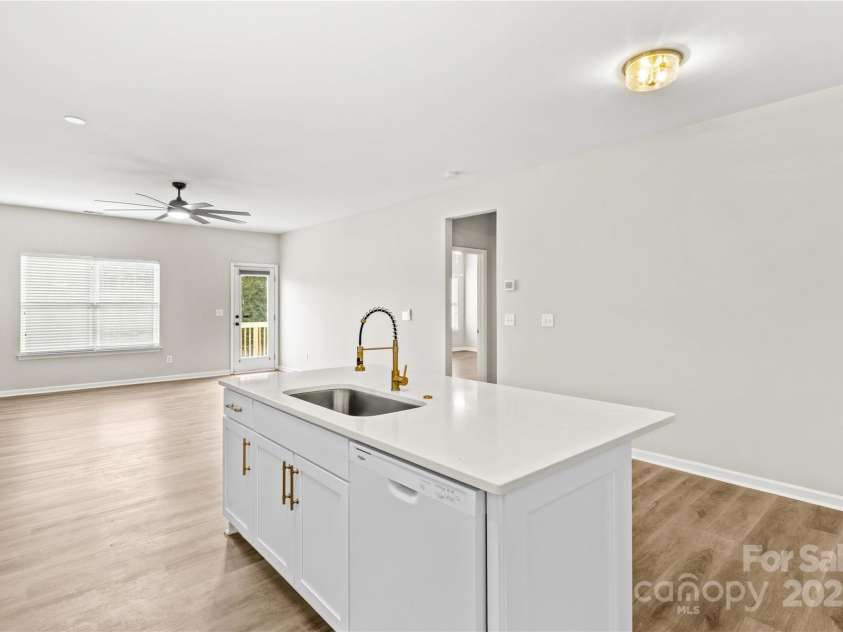 124 Zolder Lane, Mooresville, NC 28117.  MLS# CAR4213674, YatesRealty ID 6019. Kitchen Island and living area with access to back deck