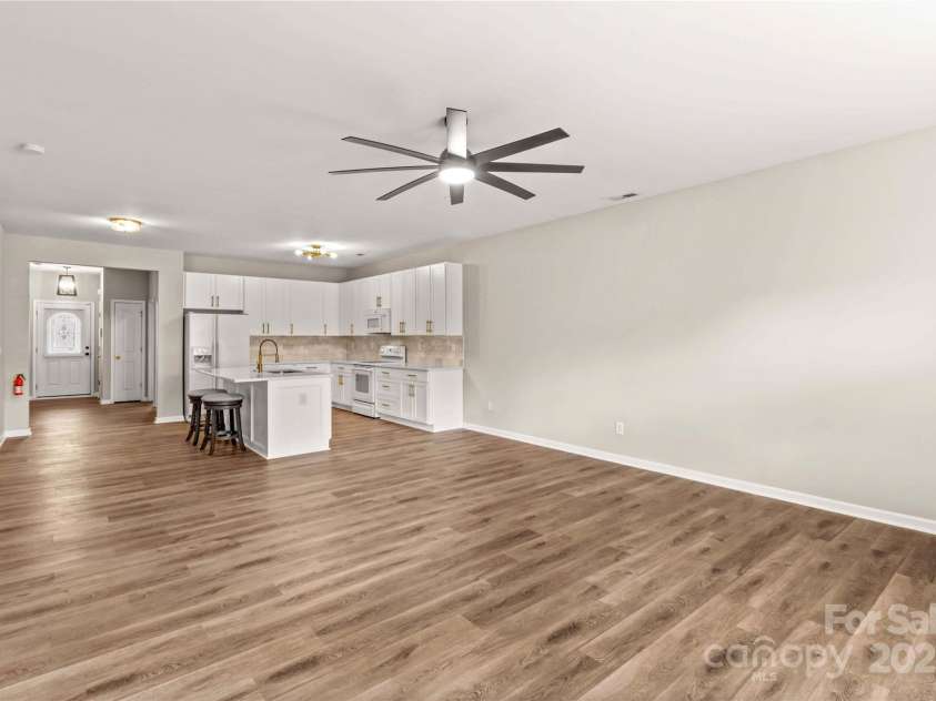124 Zolder Lane, Mooresville, NC 28117.  MLS# CAR4213674, YatesRealty ID 6019. Living area with ceiling fan