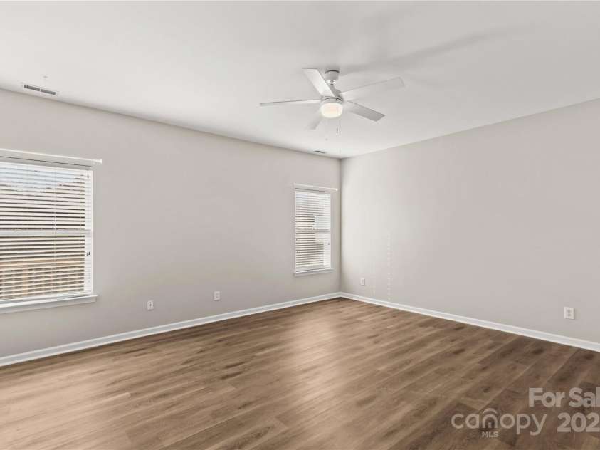 124 Zolder Lane, Mooresville, NC 28117.  MLS# CAR4213674, YatesRealty ID 6019. Primary bedroom with ceiling fan, LVP flooring