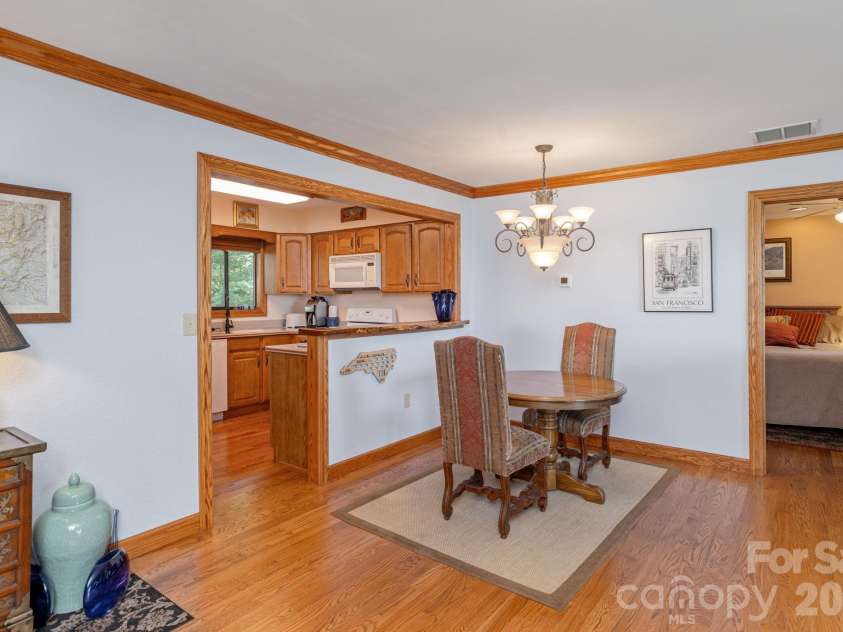 524 Three Mile Knob Road, Pisgah Forest, NC 28768.  MLS# CAR4361023, YatesRealty ID 6052. Dining area toward kitchen