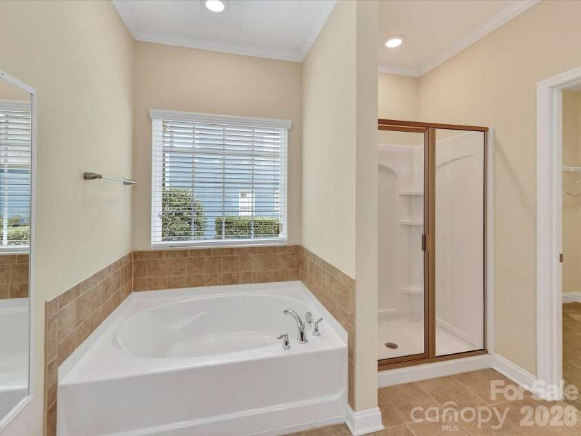 21277 Summerbrook Drive, Cornelius, NC 28031.  MLS# CAR4355875, YatesRealty ID 6062. Large soaking tub and separate shower in the Primary Bathroom