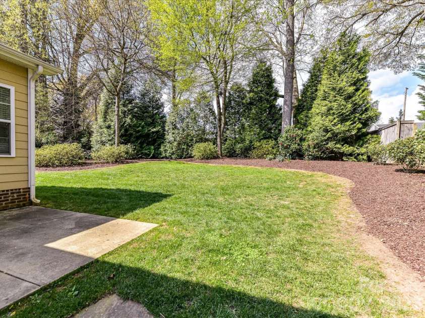 21277 Summerbrook Drive, Cornelius, NC 28031.  MLS# CAR4355875, YatesRealty ID 6062. Patio and backyard with mature landscaping