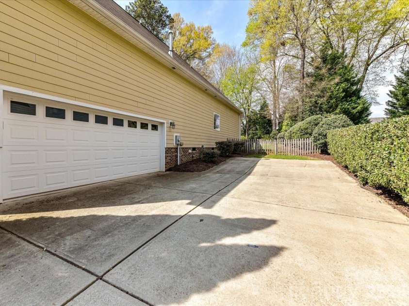 21277 Summerbrook Drive, Cornelius, NC 28031.  MLS# CAR4355875, YatesRealty ID 6062. Two-car, attached garage with additional parking spaces & play areas