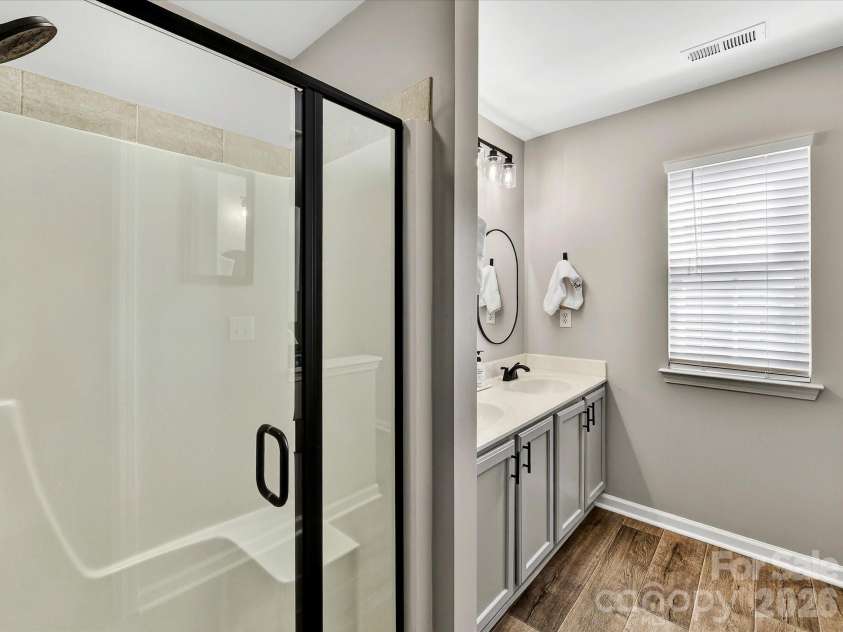12305 Chickasaw Drive, Huntersville, NC 28078.  MLS# CAR4359393, YatesRealty ID 6064. Primary bath features a spacious dual vanity and separate shower, offering both comfort and functionality.