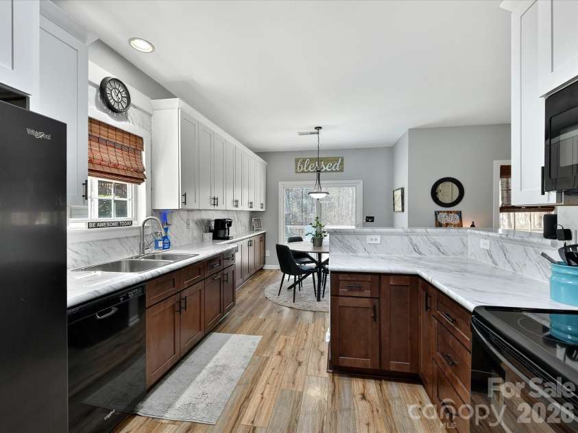12305 Chickasaw Drive, Huntersville, NC 28078.  MLS# CAR4359393, YatesRealty ID 6064. Updated kitchen featuring sleek countertops, ample cabinetry, and a functional layout that opens seamlessly to the breakfast nook.