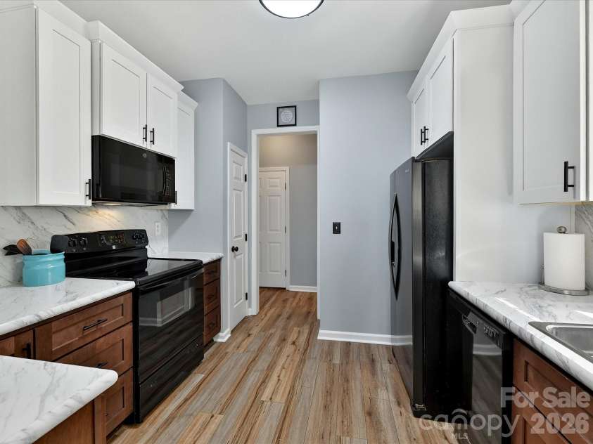 12305 Chickasaw Drive, Huntersville, NC 28078.  MLS# CAR4359393, YatesRealty ID 6064. Updated kitchen featuring sleek countertops, ample cabinetry, and a functional layout that opens seamlessly to the breakfast nook.