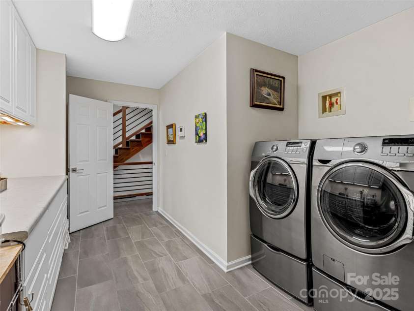 150 Hobby Horse Lane, Hendersonville, NC 28792.  MLS# CAR4241391, YatesRealty ID 6072. Spacious laundry room with nice built-ins and a wash sink