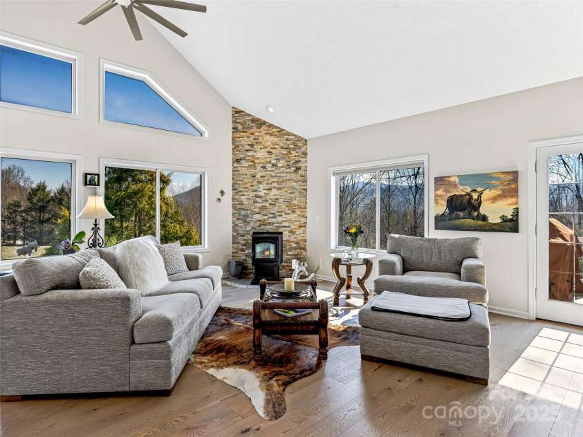 150 Hobby Horse Lane, Hendersonville, NC 28792.  MLS# CAR4241391, YatesRealty ID 6072. Thermostat controlled Pellet stove with floor to ceiling stacked stone