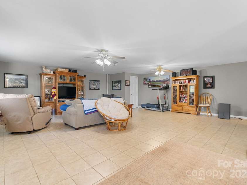 6833 Burkemont Road, Morganton, NC 28655.  MLS# CAR4189958, YatesRealty ID 6073. Family Room...all new windows in the basement and new exterior door.