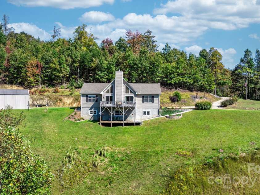 6833 Burkemont Road, Morganton, NC 28655.  MLS# CAR4189958, YatesRealty ID 6073. View of home and garage. Small area of natural habitat for the birds, turtles and turkeys.