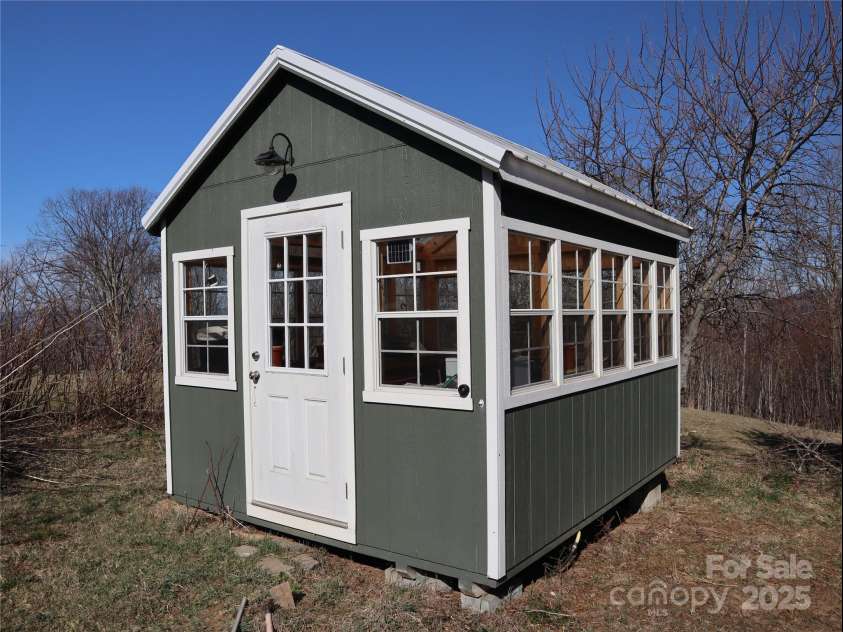 672/715 Windswept Ridge Road, Canton, NC 28716.  MLS# CAR4229345, YatesRealty ID 6077. Green house with a large garden area.