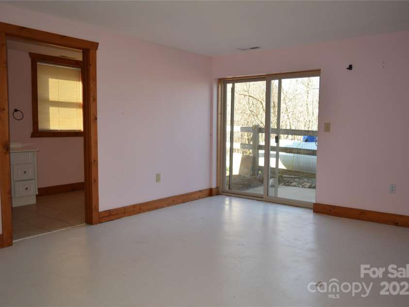 672/715 Windswept Ridge Road, Canton, NC 28716.  MLS# CAR4229345, YatesRealty ID 6077. House #1 - Bedroom in basement with full bath.  Access to outside with small patio area.