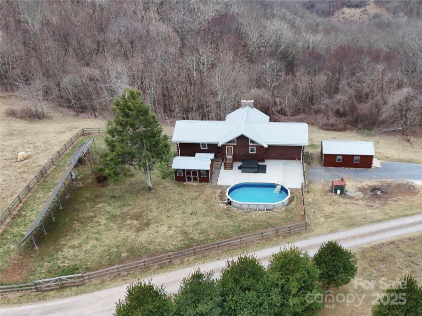672/715 Windswept Ridge Road, Canton, NC 28716.  MLS# CAR4229345, YatesRealty ID 6077. House #1 - Cabin with outdoor hot tub, pool, detached garage, and pool shed.