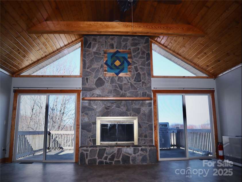 672/715 Windswept Ridge Road, Canton, NC 28716.  MLS# CAR4229345, YatesRealty ID 6077. House #1 Stone woodburning fireplace that opens to a back deck with mountain views. Open Floor Plan.