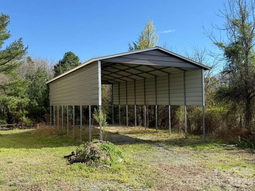 6875 Mount Pleasant Road, Concord, NC 28025.  MLS# CAR4361552, YatesRealty ID 6090. Oversized carport designed to accommodate RV storage.