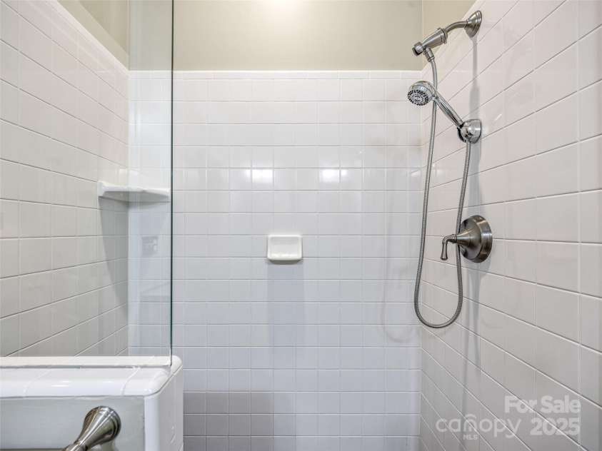 73 Ridgetop Circle, Brevard, NC 28712.  MLS# CAR4307459, YatesRealty ID 6094. Sleek primary frameless shower