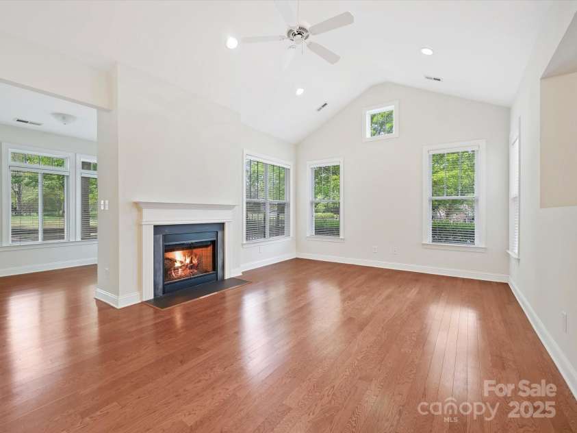 1910 Mezzo Court, Matthews, NC 28105.  MLS# CAR4245911, YatesRealty ID 6115. Living room with gas fireplace and beautiful hardwood floors