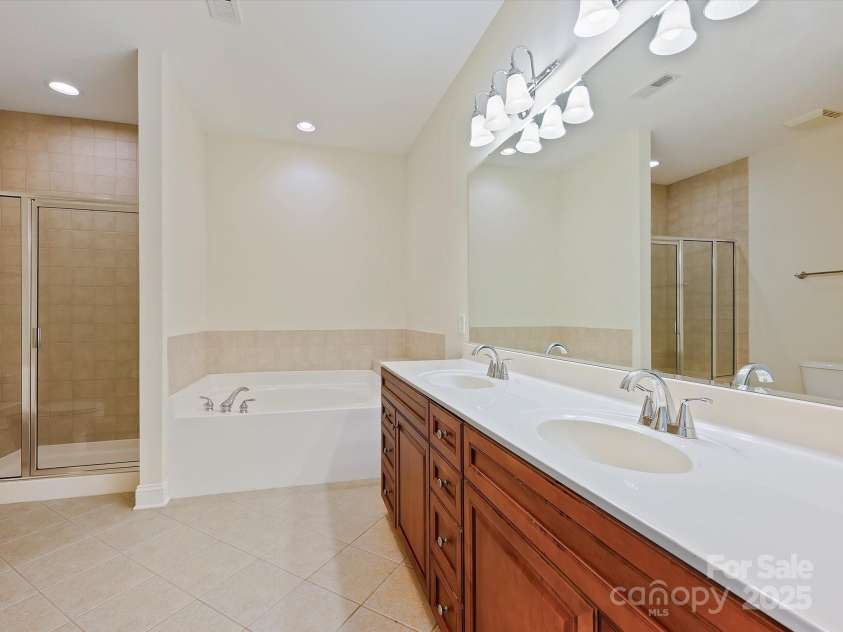 1910 Mezzo Court, Matthews, NC 28105.  MLS# CAR4245911, YatesRealty ID 6115. Primary Bathroom with new faucets, garden tub and separate shower.