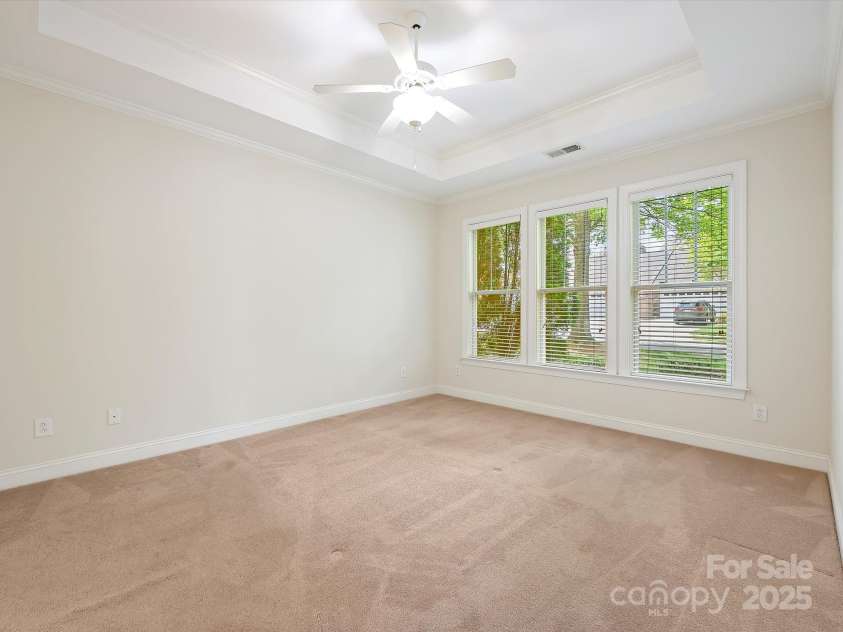 1910 Mezzo Court, Matthews, NC 28105.  MLS# CAR4245911, YatesRealty ID 6115. Primary bedroom with ceiling fan