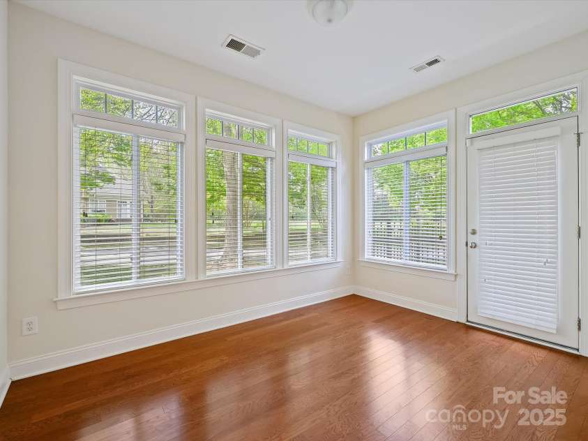 1910 Mezzo Court, Matthews, NC 28105.  MLS# CAR4245911, YatesRealty ID 6115. Sunroom with transom windows and door exiting to side patio