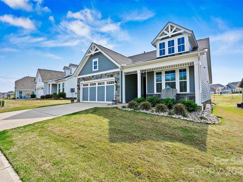 8718 Festival Way, Charlotte, NC 28215.  MLS# CAR4243722, YatesRealty ID 6122. Showcasing stone accents, a sleek metal accent roof, decorative corbels and low-maintenance fiber cement siding for a timeless, upscale look.