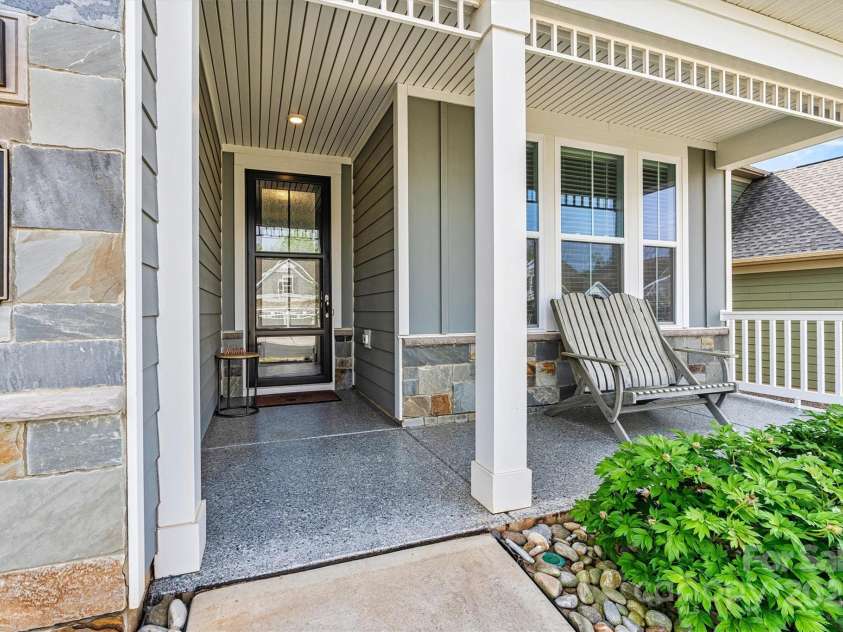 8718 Festival Way, Charlotte, NC 28215.  MLS# CAR4243722, YatesRealty ID 6122. Step onto the Epoxy-coated front porch that adds both durability and charm—perfect for enjoying your morning coffee or saying 