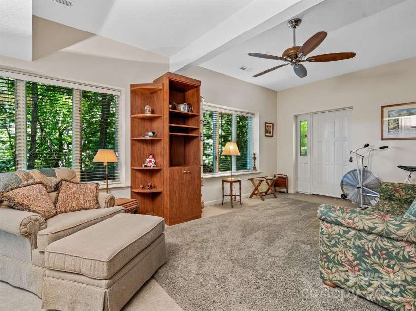 140 Grouse Lane, Brevard, NC 28712.  MLS# CAR4247266, YatesRealty ID 6128. Large lakeside windows.