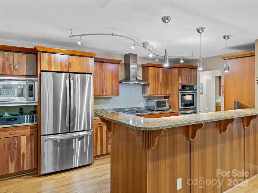 140 Grouse Lane, Brevard, NC 28712.  MLS# CAR4247266, YatesRealty ID 6128. Open to dining so the cooks can enjoy guests.