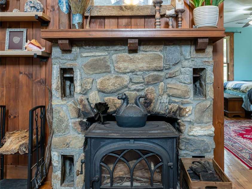 20 Meeks Road, Black Mountain, NC 28711.  MLS# CAR4232565, YatesRealty ID 6129. Original fireplace with Jotul woodstove