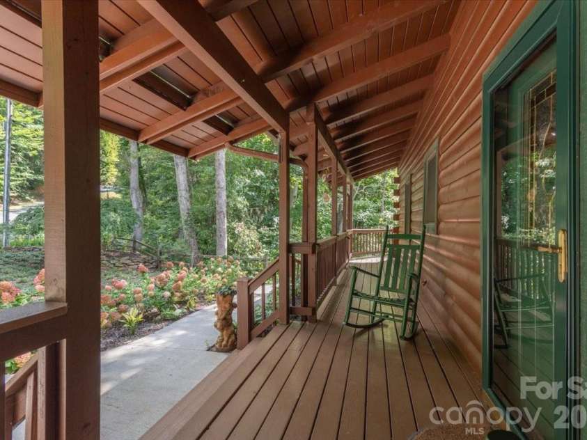 235 Timucua Trail, Waynesville, NC 28786.  MLS# CAR4301389, YatesRealty ID 6129. Rocking Chair front porch.