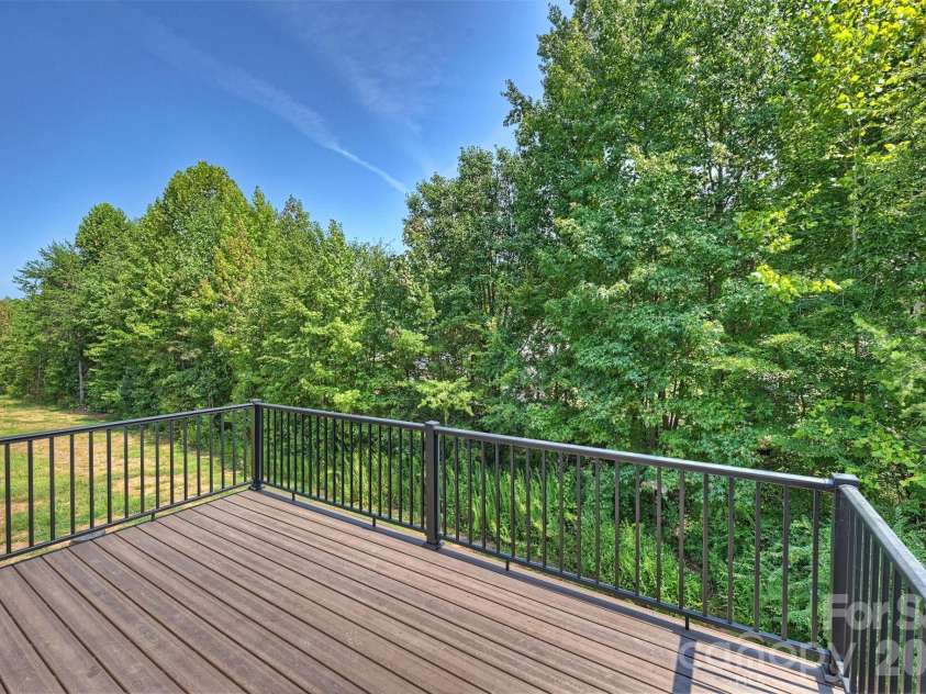 126 Meadow Glen Drive, Troutman, NC 28166.  MLS# CAR4340501, YatesRealty ID 6147. Large rear deck with composite boards and black railing.