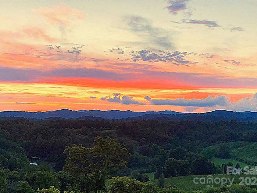 1387 Woods Ammons Road, Mars Hill, NC 28754.  MLS# CAR4303363, YatesRealty ID 6175. Back Primary BR Terrace at Sunset - Seller Provided