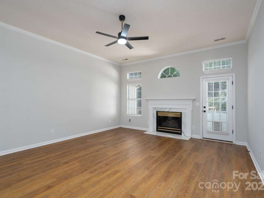6111 Tesh Court, Charlotte, NC 28269.  MLS# CAR4239195, YatesRealty ID 6183. Large living room with new floors and gas fireplace