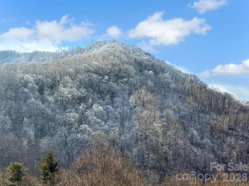 24 Hawthorn Road, Maggie Valley, NC 28751.  MLS# CAR4342542, YatesRealty ID 6190. Views of several ridges from deck