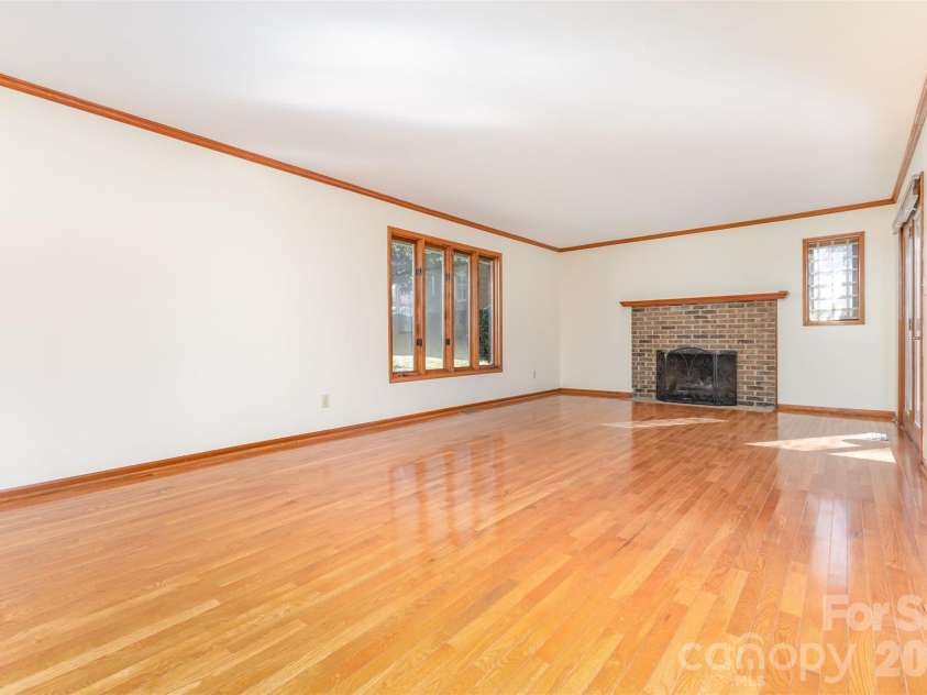 1716 Arbor Way Drive, Shelby, NC 28150.  MLS# CAR4321093, YatesRealty ID 6200. The spacious family room with a gas log fireplace and gleaming hardwood floors,...