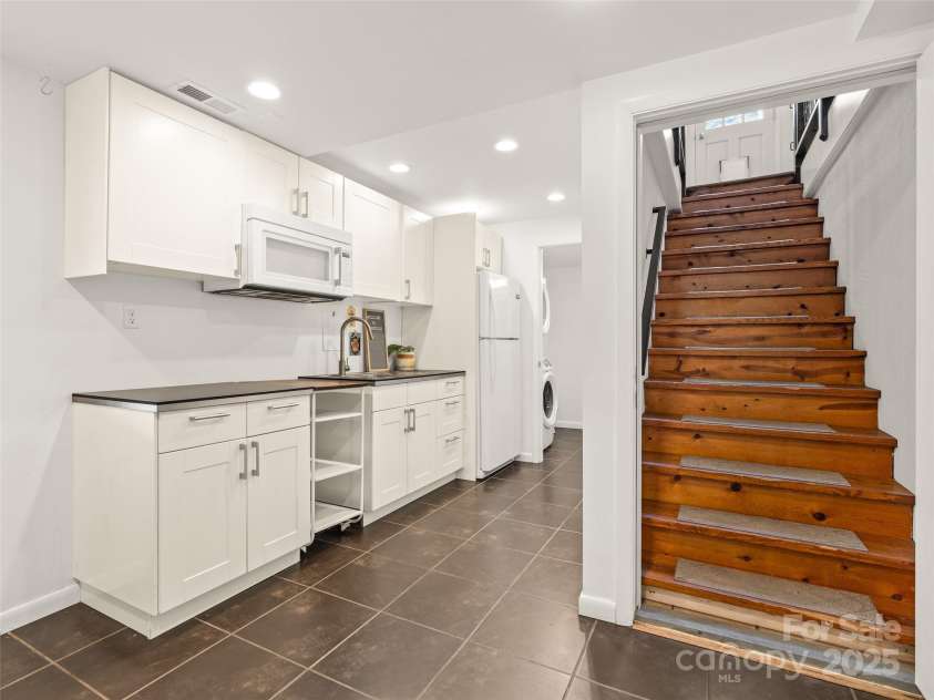 93 Morningside Drive, Asheville, NC 28806.  MLS# CAR4244401, YatesRealty ID 6214. Stairs into the basement space.