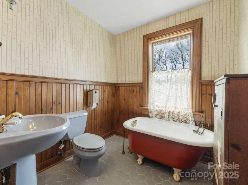44 Bickford Avenue, Tryon, NC 28782.  MLS# CAR4245454, YatesRealty ID 6231. Full bath with vintage clawfoot tub on main