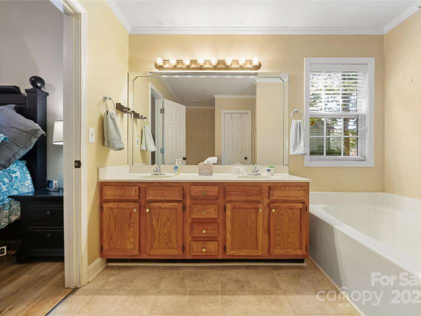 269 Fryling Avenue, Concord, NC 28025.  MLS# CAR4311913, YatesRealty ID 6246. Primary bath's vanity area with huge mirror plus window. 