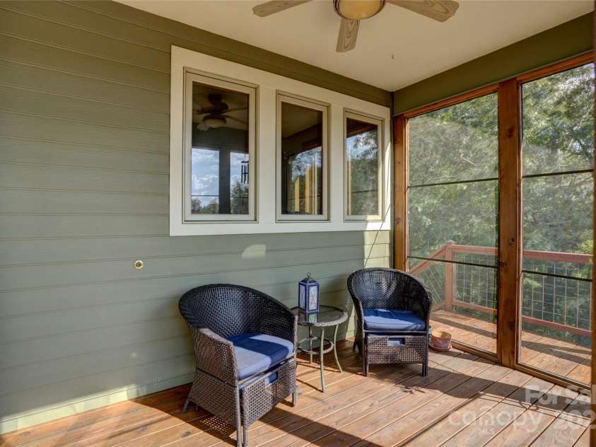 425 Sawmill Creek Road, Bryson City, NC 28713.  MLS# CAR4234274, YatesRealty ID 6247. Screened Porch off Kitchen in Back