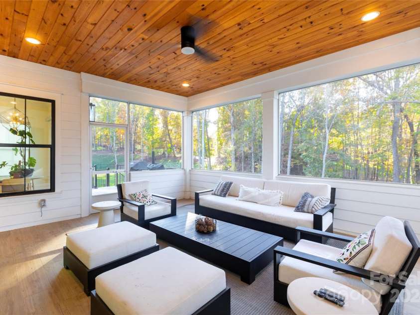 124 Direct Drive, Mooresville, NC 28117.  MLS# CAR4202552, YatesRealty ID 625. Beautiful pine ceiling makes this amazing screened in porch so cozy!