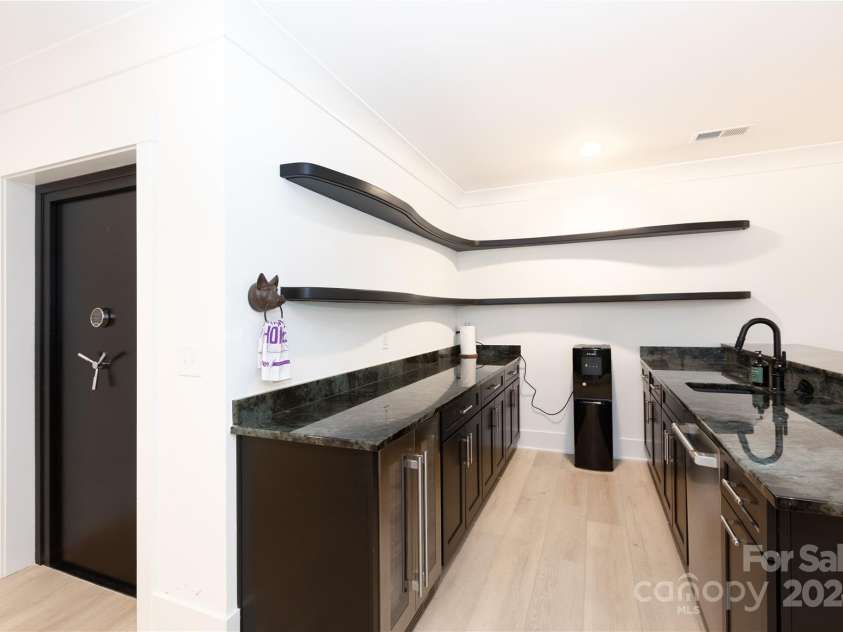 124 Direct Drive, Mooresville, NC 28117.  MLS# CAR4202552, YatesRealty ID 625. Entertaining bar w/Labradorite counters, beverage fridge and dishwasher.