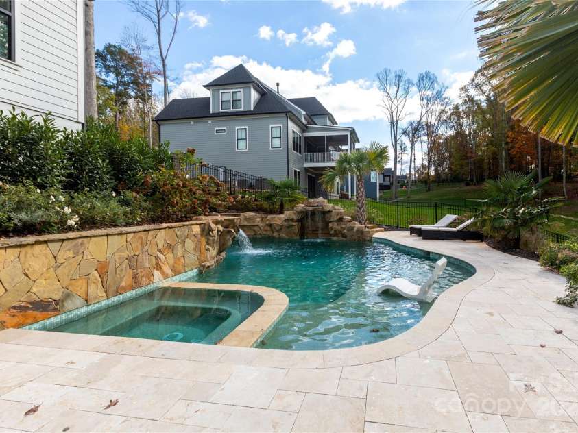 124 Direct Drive, Mooresville, NC 28117.  MLS# CAR4202552, YatesRealty ID 625. Saltwater pool with 2 waterfalls, tanning ledge & hot tub.